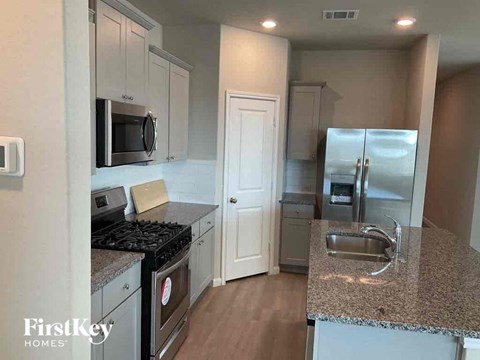 a kitchen with stainless steel appliances and granite counter tops