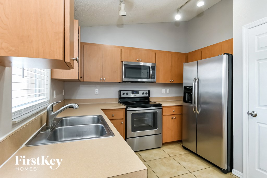 a kitchen with stainless steel appliances and wooden cabinets