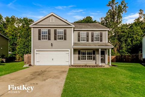 A two-story house with a garage is for sale.