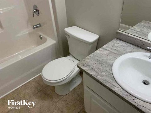 a bathroom with a toilet and a sink and a tub