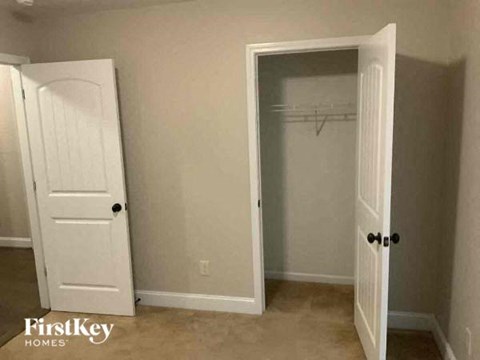 a room with a closet and an open door