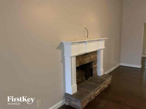 a living room with a fireplace and a hard wood floor