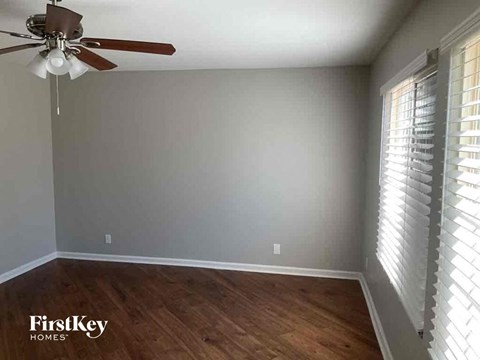 a living room with a wood floor and a ceiling fan