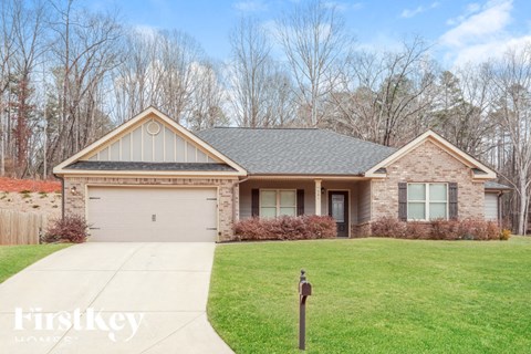 A house with a grey roof and a white garage door.