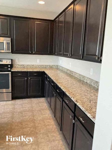 a kitchen with a granite counter top and black cabinets