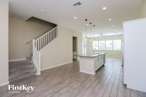 the kitchen and living room are open to the dining room and stairwell