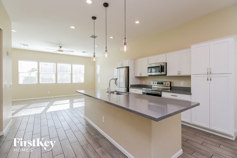 a large kitchen with white cabinets and a counter top