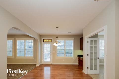 A well-lit, spacious room with a chandelier hanging from the ceiling.
