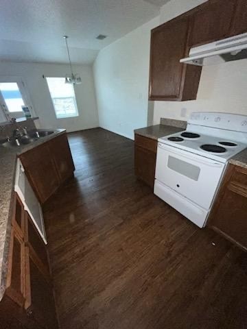 an empty kitchen with a stove and a sink