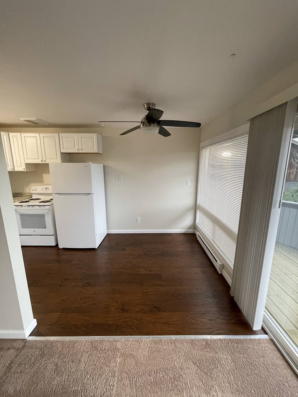 a kitchen with a ceiling fan and a window