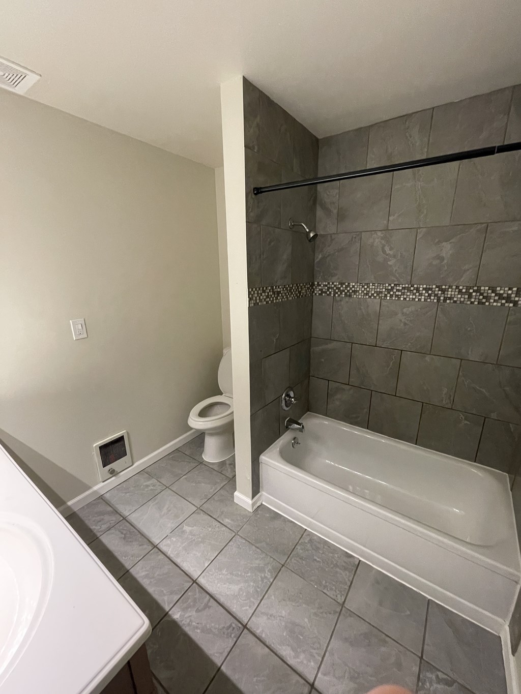 a bathroom with a tub and a toilet and a sink