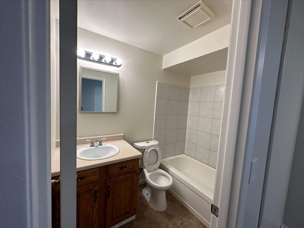 a bathroom with a sink toilet and bath tub