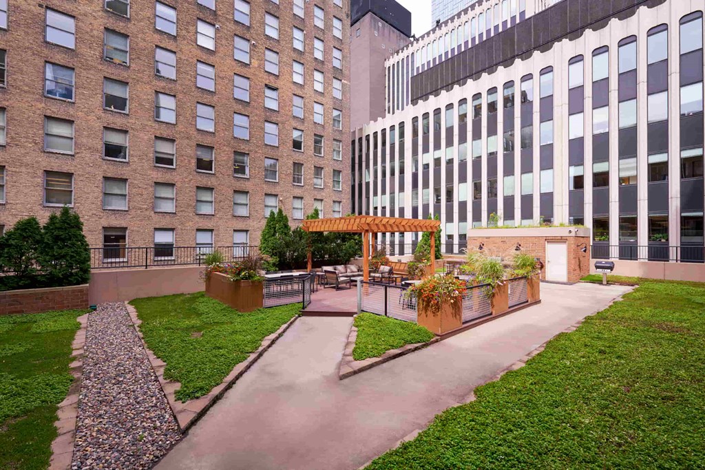 A courtyard with a grassy area and a walkway.