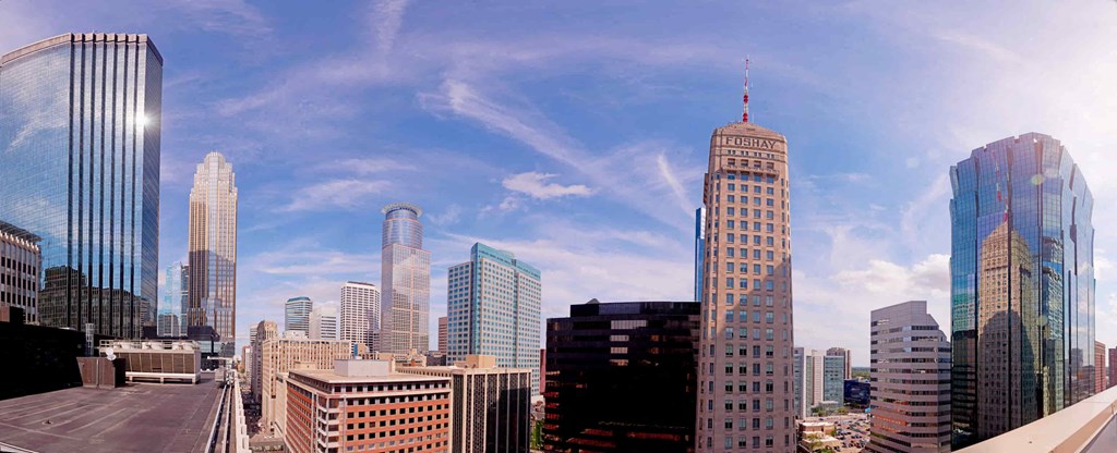 A cityscape with tall buildings and a clear sky.
