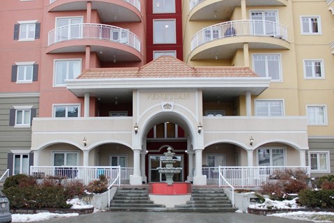 a view of the front entrance of a building with a fountain