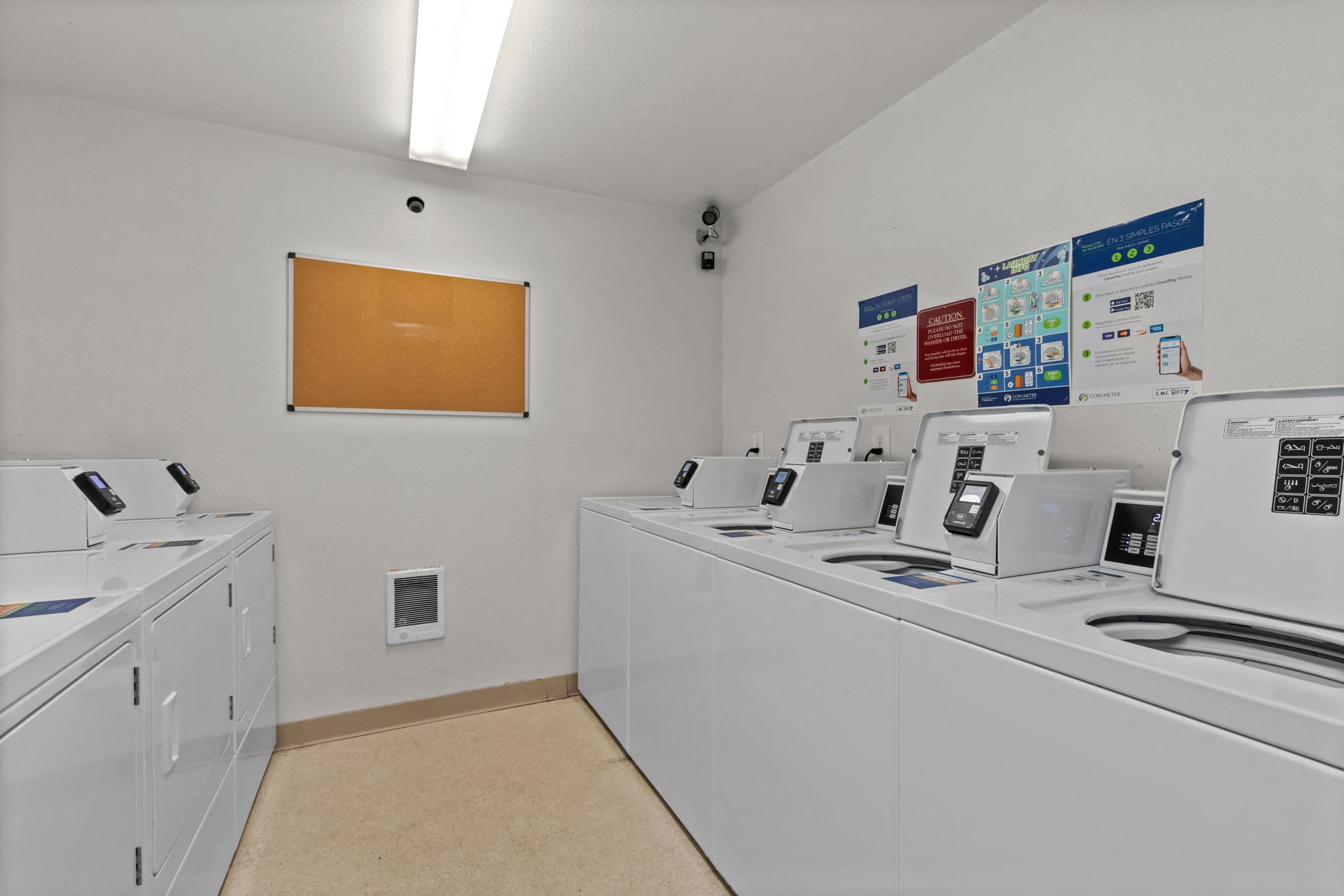 our laundry room is equipped with washes and dryers and has a bulletin board