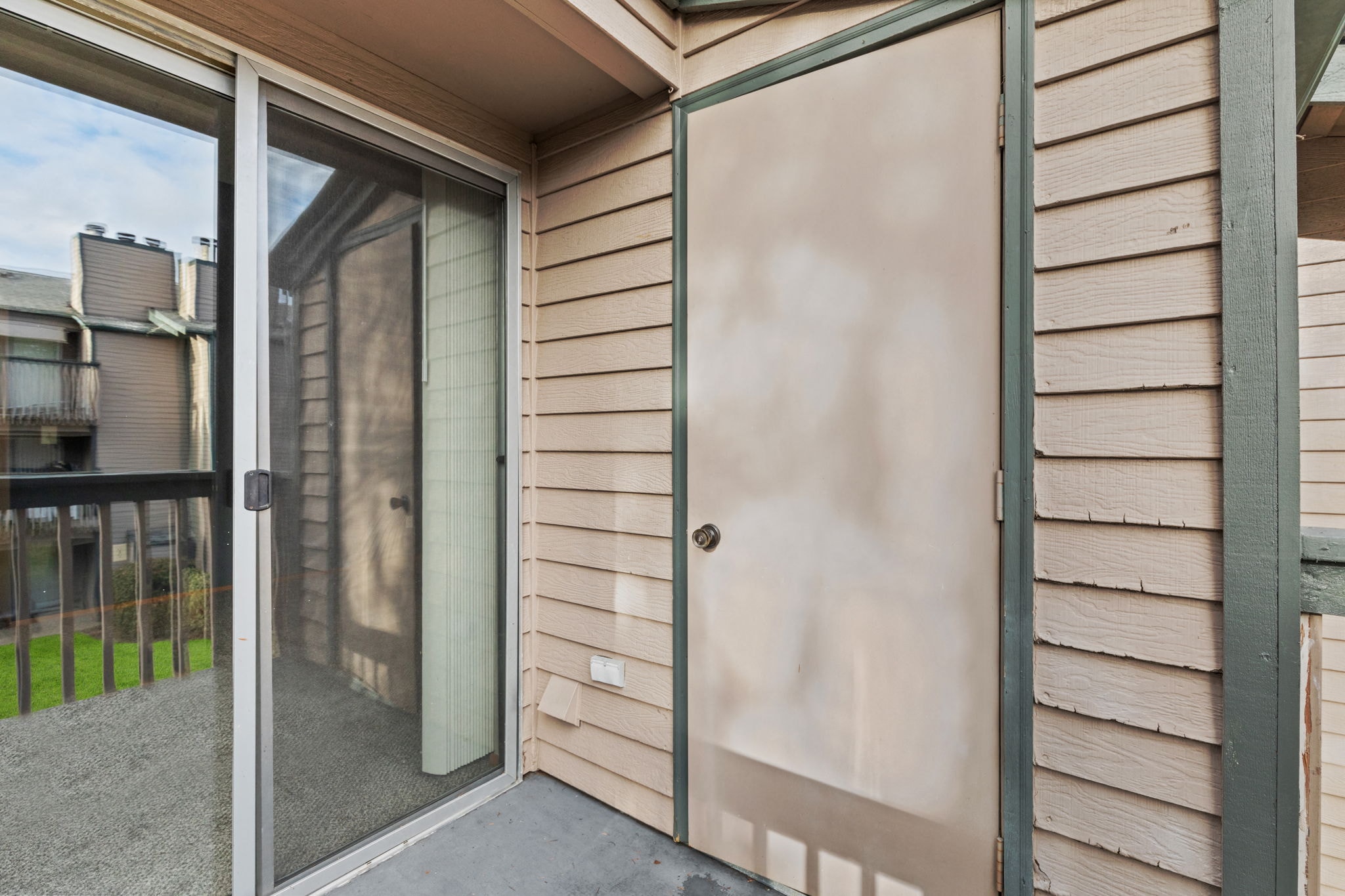 the front door of a house with glass sliding doors