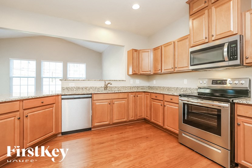 A kitchen with wooden cabinets and stainless steel appliances.