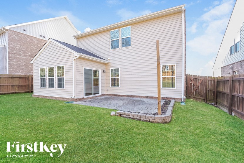 A house with a white exterior and a small patio area.