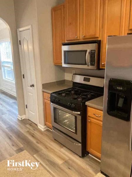 a kitchen with stainless steel appliances and wooden cabinets
