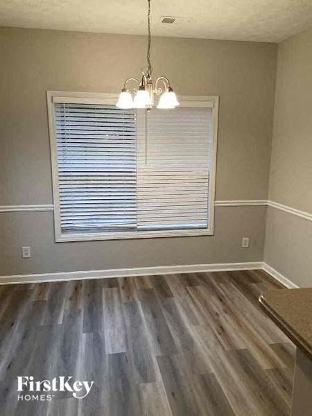 a living room with a window and wood floors