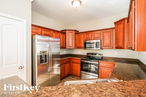 A kitchen with wooden cabinets and stainless steel appliances.