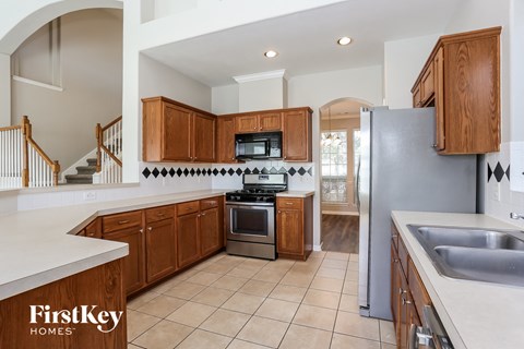 a kitchen with wooden cabinets and stainless steel appliances