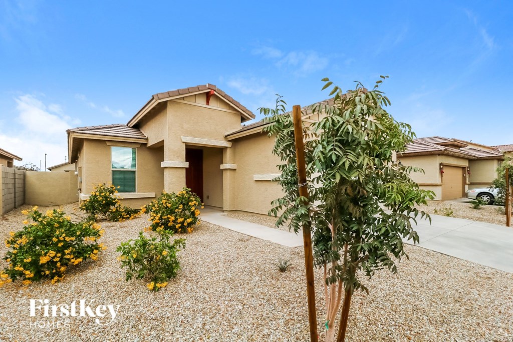 a house with a yard and a tree in front of it