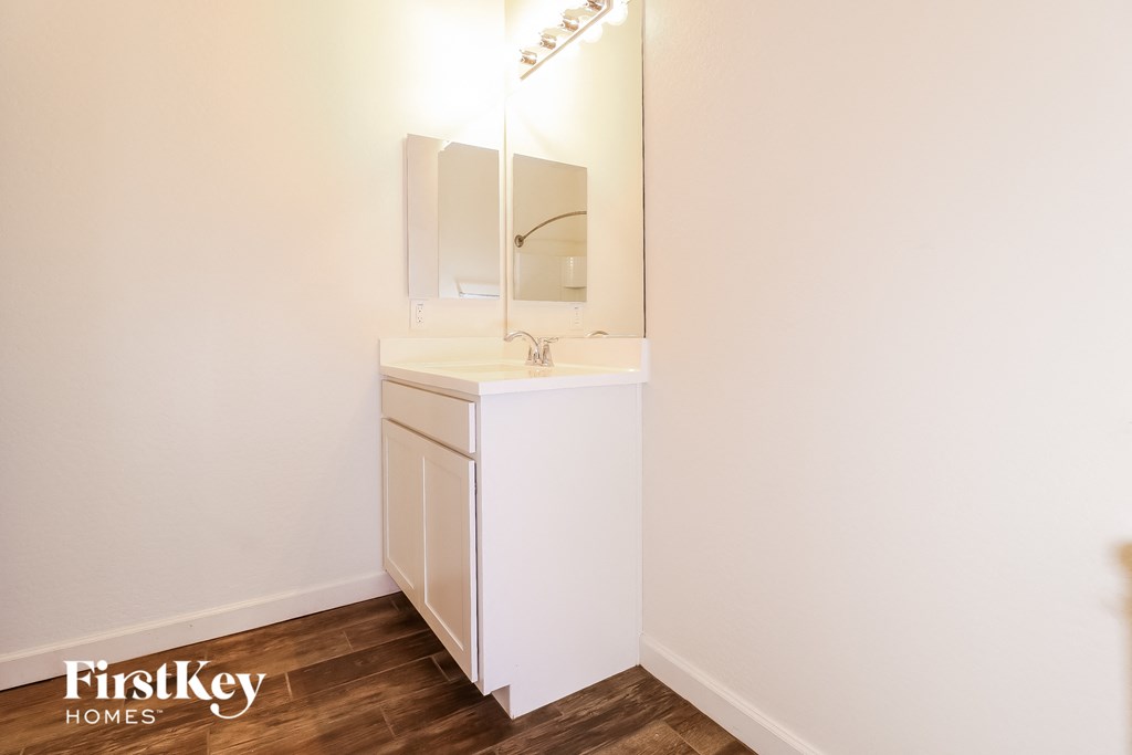 a small bathroom with a sink and a mirror
