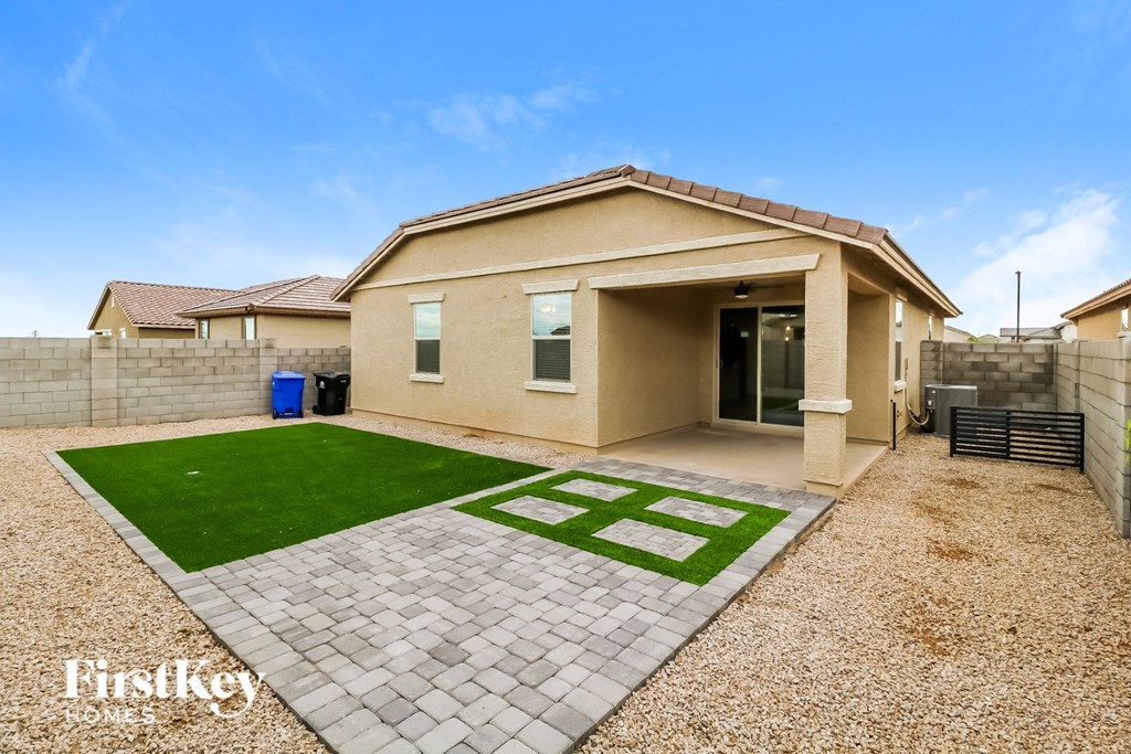 a home with a driveway and lawn in front of it