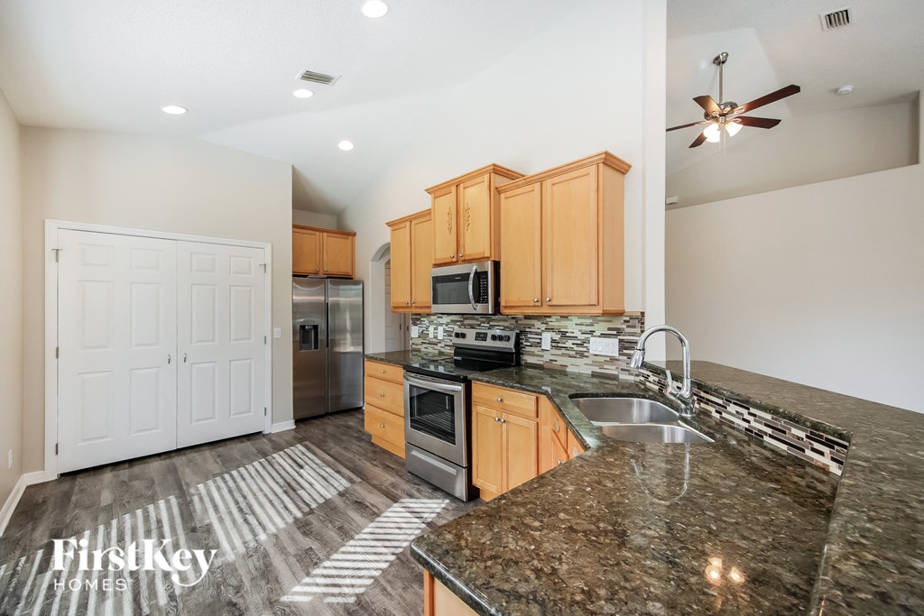 the kitchen is updated with granite counter tops and stainless steel appliances