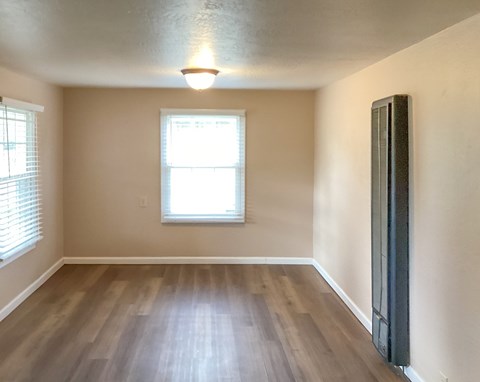 A room with a window and a radiator on the wall.