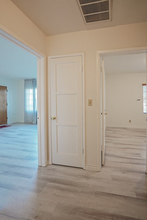 a view of the living room from the hallway with the door open to the bedroom
