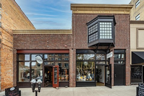 the storefront of a brick building with a window