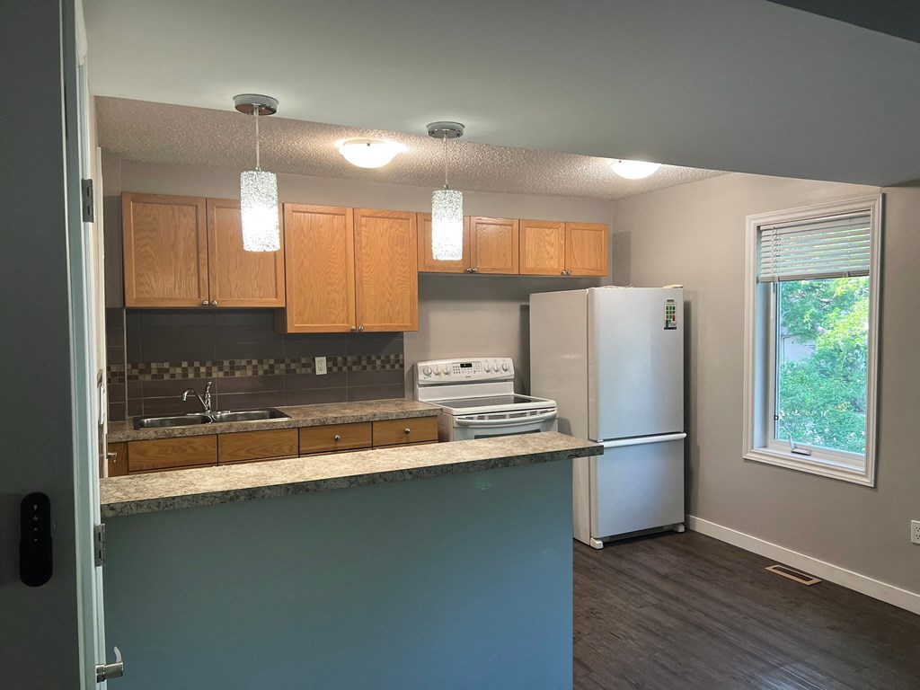 a kitchen with a counter top and a refrigerator