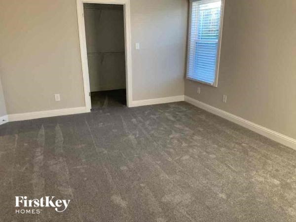 a room with a carpeted floor and a closet