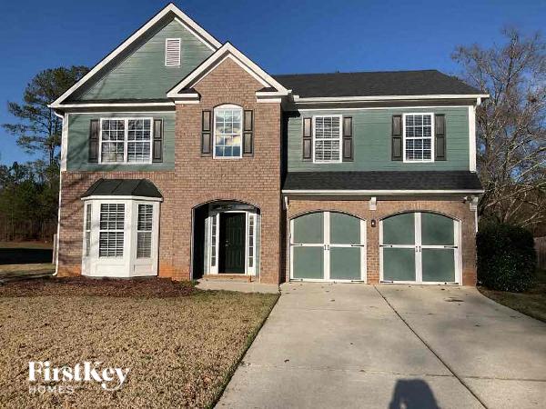 a brick house with a sidewalk in front of it