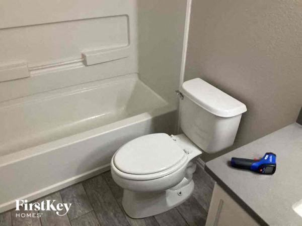 a bathroom with a toilet and a bath tub
