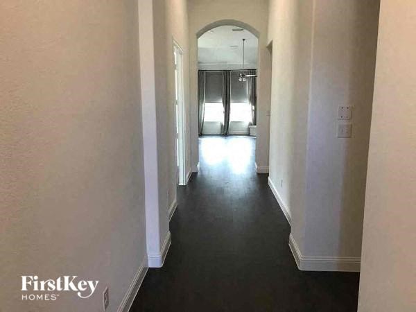 A long hallway with a FirstKey Homes logo on the bottom left.