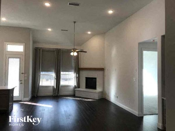 A spacious living room with a fireplace and sliding glass doors.