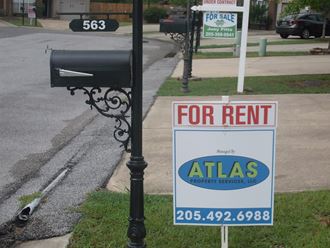 a for rent sign on the side of a street
