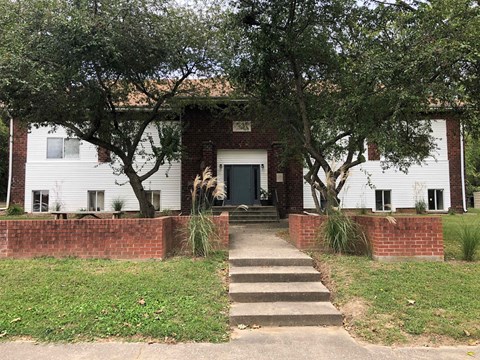 a white house with stairs in front of it
