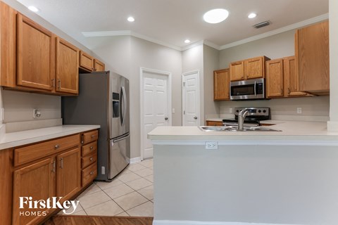 a kitchen with wooden cabinets and a white counter top
