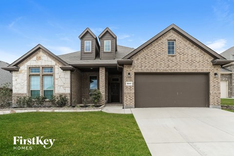 a home with a garage door in front of it