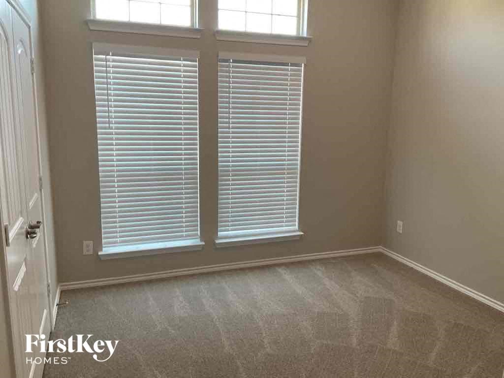 a room with two windows and a carpeted floor