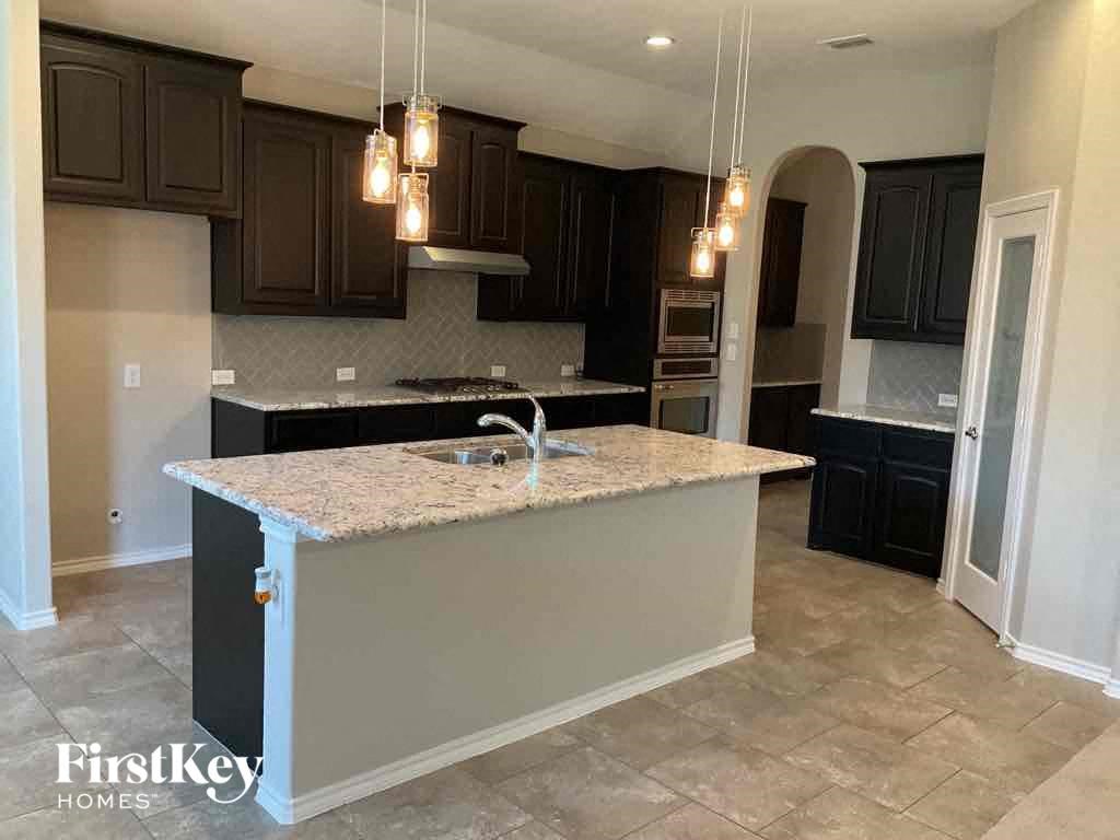 a kitchen with black cabinets and a counter top