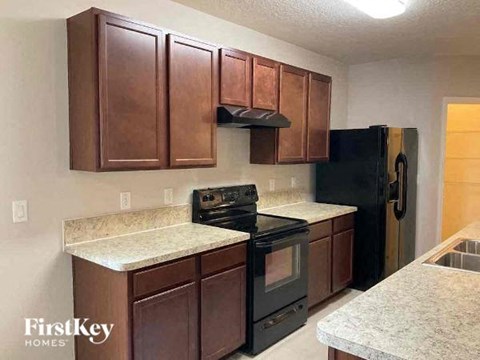 a kitchen with a stove and a refrigerator