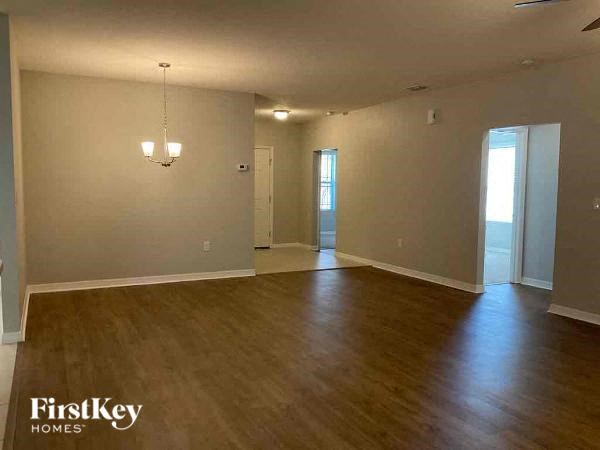 an empty living room with a hard wood floor