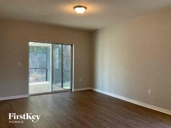an empty living room with a sliding glass door