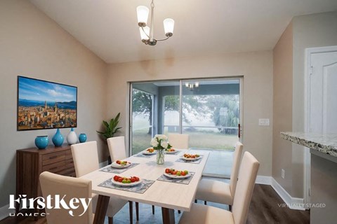 A dining room with a table set for a meal.